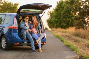 Couple sitting in the back of a hatchback car